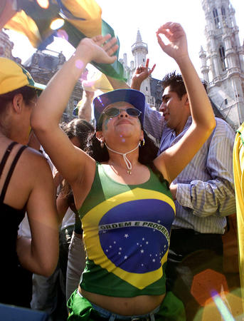 A Brazilian soccer fan celebrates victory after watching a broadcast of her team's World Cup second round match against Belgium at Brussels' Grand Place on June 17, 2002. Brazil won the match 2-0, advancing to the quarter-finals against England.