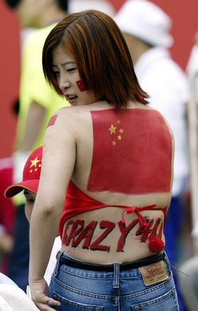A Chinese soccer fan with the Chinese flag painted on her back stands inside the stadium before a Group C match between China and Turkey at the World Cup Finals in Seoul, June 13, 2002