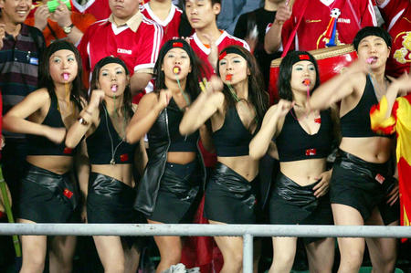 Chinese soccer fans cheer for their team during a pre-World Cup warm-up match against Uruguay in Shenyang, capital of China's northeastern province of Liaoning, on May 16, 2002.