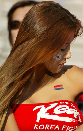 A South Korean fan dresses in team colours prior to the World Cup semi-final match against Germany in Seoul, June 25, 2002