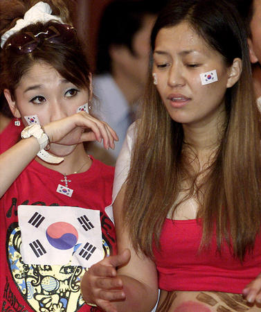 South Koreans in Hong Kong react after Germany scored a goal against South Korea during their World Cup semi-final match in Seoul June 25, 2002.